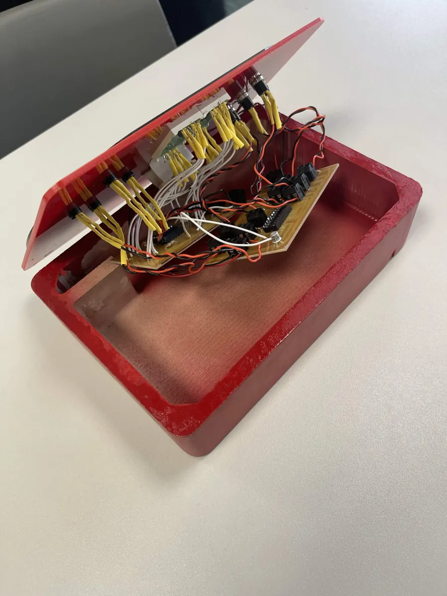 Reaction-time game opened up, showing the hand-soldered wiring and custom carved PCB